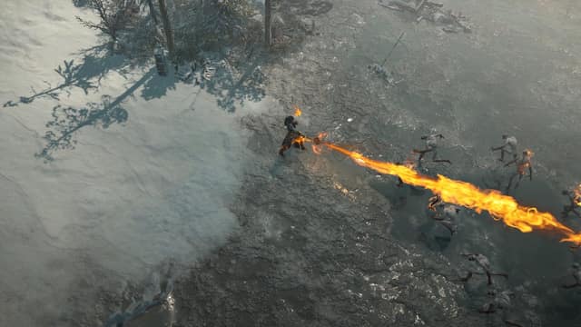 Un personnage projette un long jet de flammes sur un groupe d'ennemis au bord d'une étendue enneigée dans Diablo IV