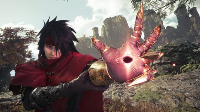 Vincent Valentine, cape rouge, tend sa main gantée de métal au-dessus d'un paysage rocheux dans Final Fantasy VII Revelation