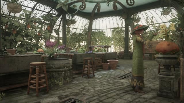 La serre de botanique de Poudlard, pleine de plantes, avec une professeure en robe verte