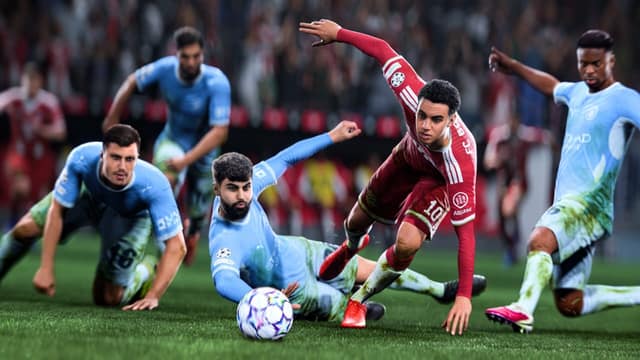 Plusieurs joueurs au sol se disputent le ballon devant le but