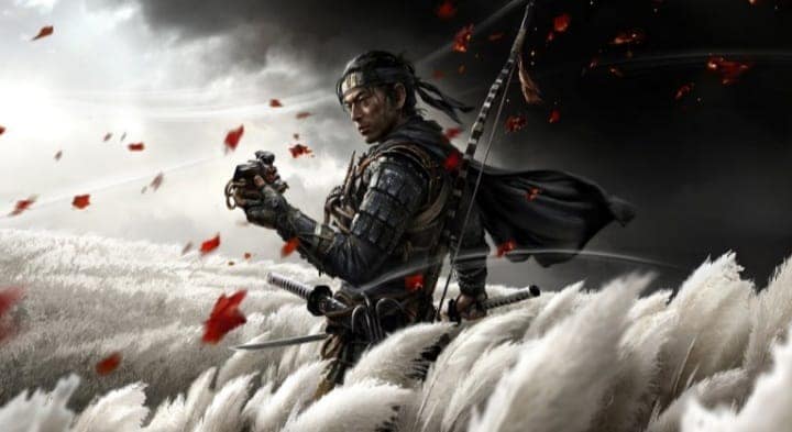 Ghost of Tsushima : Jin Sakai dégaine son katana dans un champ balayé par le vent