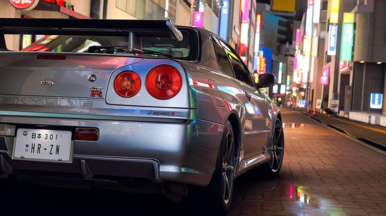 Nissan Skyline GT-R garée dans une rue de Tokyo éclairée par des enseignes au néon, la nuit
