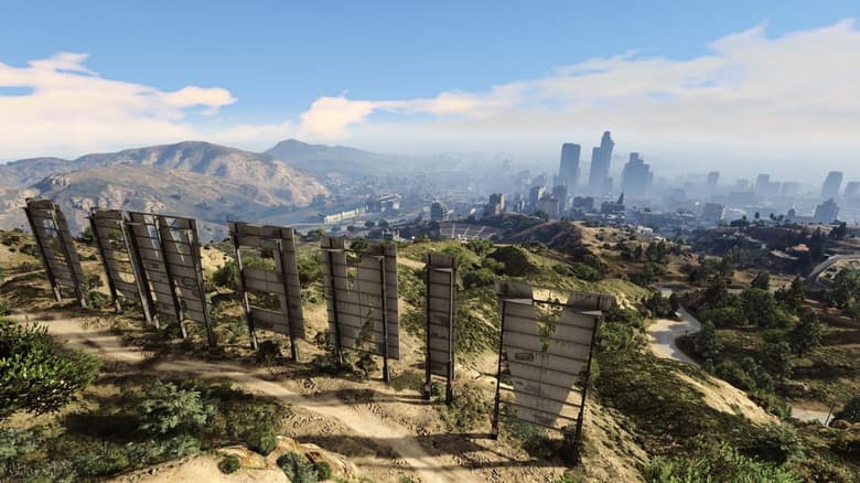 Vue de Los Santos depuis la colline des lettres Vinewood, avec les gratte-ciel du centre au loin sous un ciel dégagé