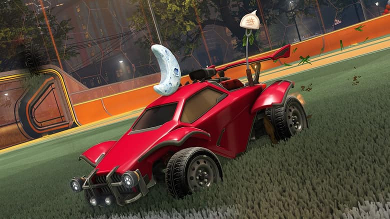Une voiture Octane rouge sur la pelouse d'un stade de Rocket League
