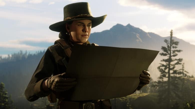 Une joueuse de Red Dead Online, chapeau sur la tête, déplie une carte devant des montagnes