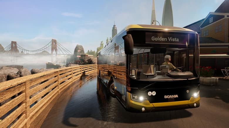 Bus Scania jaune et noir affichant Golden Vista, sur une route au bord de l'eau avec un pont suspendu au fond