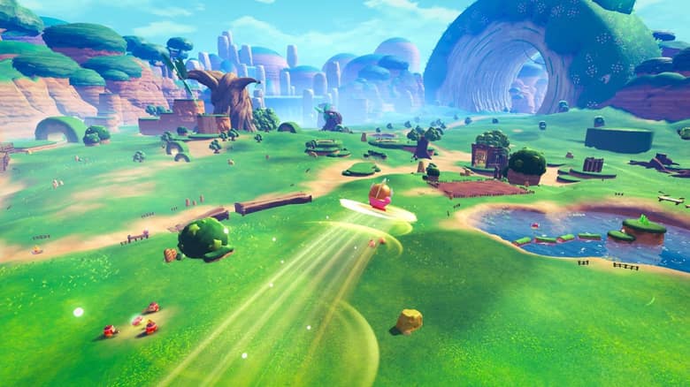 Kirby file sur une étoile au-dessus d'une immense plaine verte, avec des collines et des ruines à l'horizon
