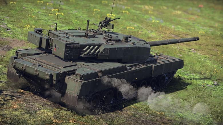Un char de combat moderne vert, chenilles dans l'herbe, roule dans une prairie