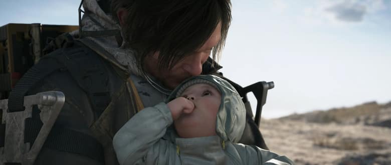 Sam Porter Bridges serre un bébé dans ses bras, dans un paysage désertique