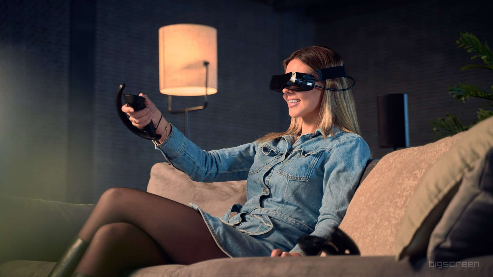 Bigscreen-Beyond-VR-headset-worn-by-a-woman-sitting-on-a-couch
